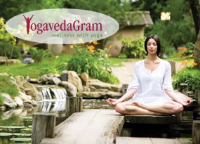 A woman meditating peacefully on a wooden bridge in a serene garden setting.