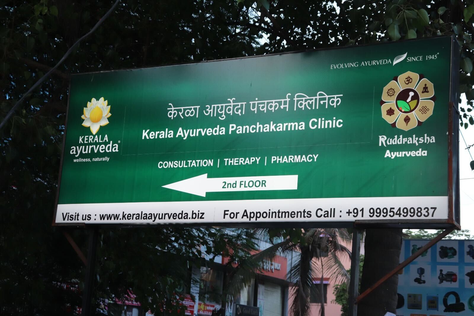 Sign for Kerala Ayurveda Panchakarma Clinic with details on services and contact information.