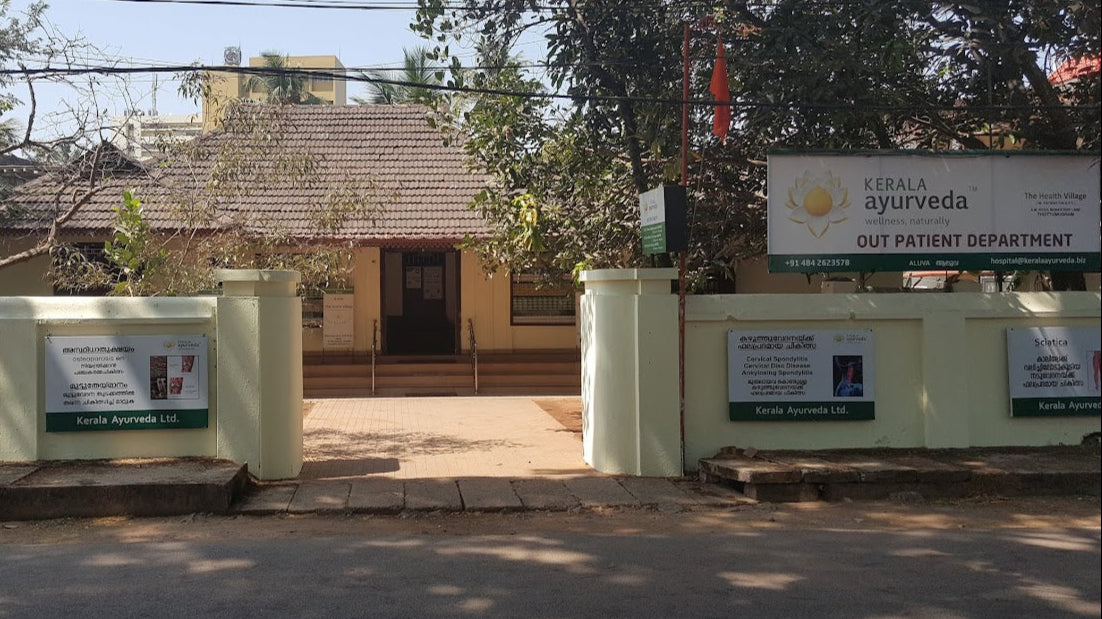 Exterior view of the Kerala Ayurveda outpatient department building and signage.