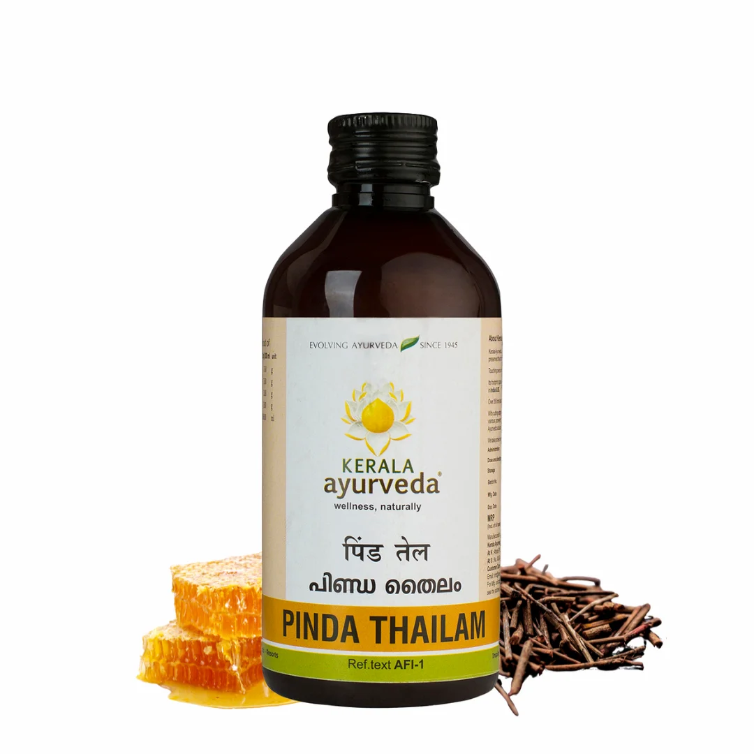 Hero image of Kerala Ayurveda Pinda Thailam bottle flanked by honeycomb and manjishta roots, emphasising its cooling, anti-inflammatory base – Kerala Ayurveda India