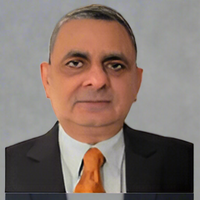 A man in a suit and tie with a gray background.