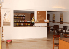 Interior of a wellness center featuring shelves of products, a reception counter, and seating.