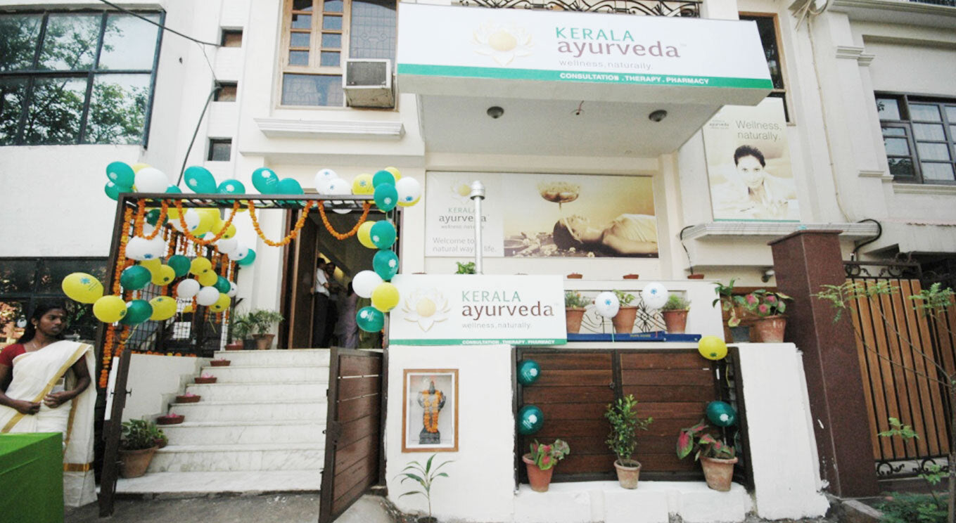 Entrance of Kerala Ayurveda center with balloons and decorations.